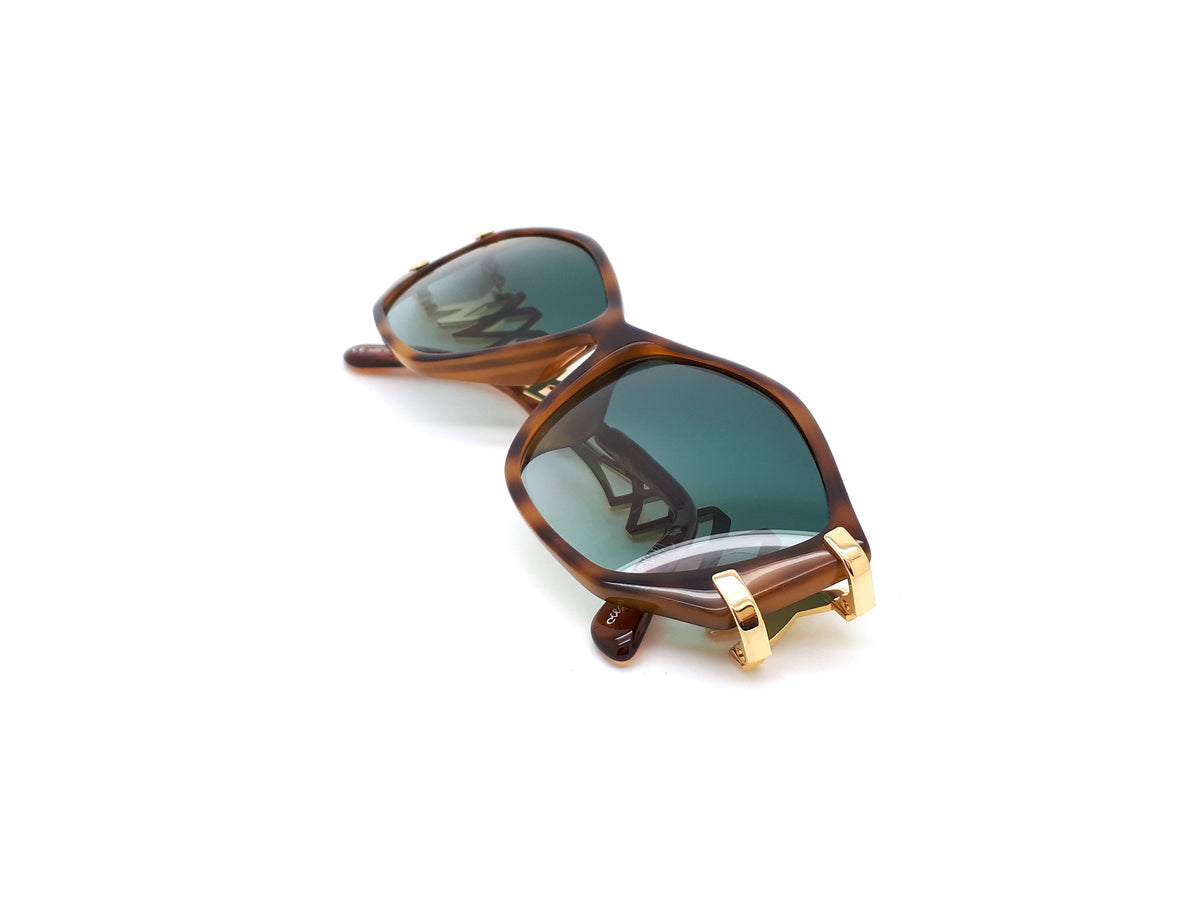Paloma Picasso sunglasses with green lenses