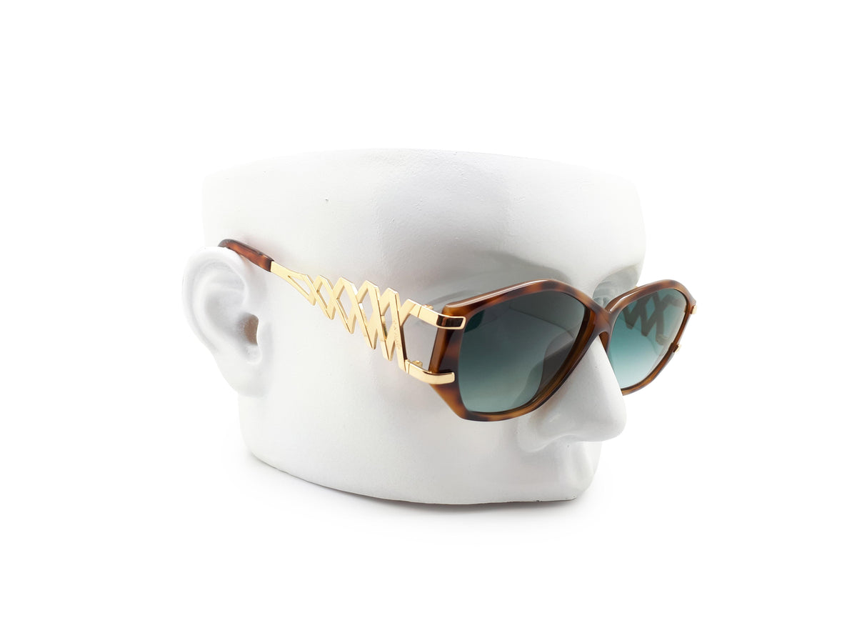 Paloma Picasso sunglasses with green lenses
